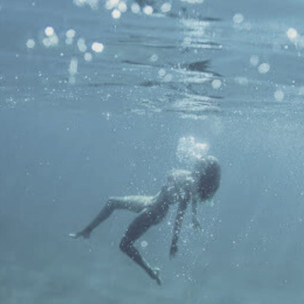 Person floating peacefully underwater representing the Escape 90-minute massage session at Lahaina Luxury Health Spa. Photograph by Kelly Hsiao